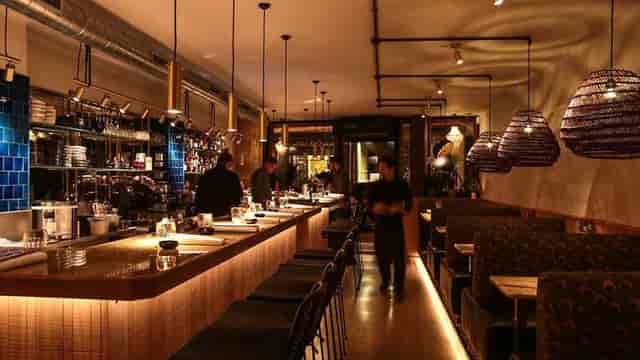 Modern restaurant bar with ambient lighting, ideal for cocktail receptions and corporate meetings.