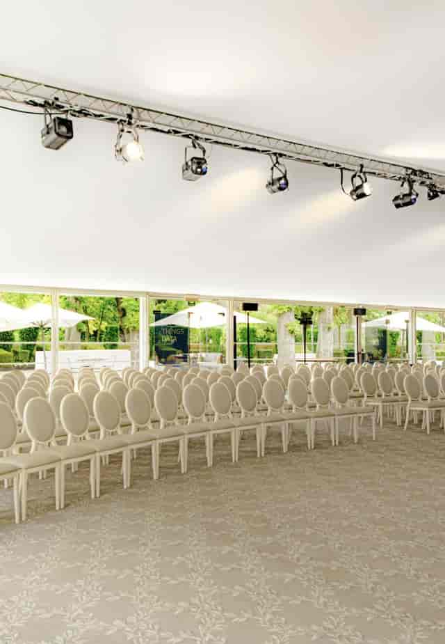Elegant white chairs in Jardin d'hiver, perfect for conferences and weddings.