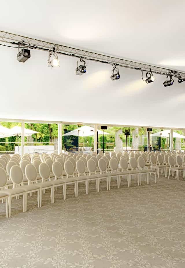 Elegant white chairs in Jardin d'hiver, perfect for conferences and weddings.