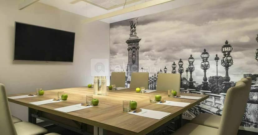 Modern meeting room at Meliá Paris La Défense with wooden table and elegant decor.