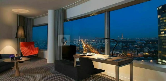 Cesar in stylish Meliá Paris La Défense room with Eiffel Tower view for business events.
