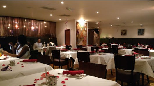 Elegant Zari Restaurant venue with white linens, perfect for intimate events and gatherings.