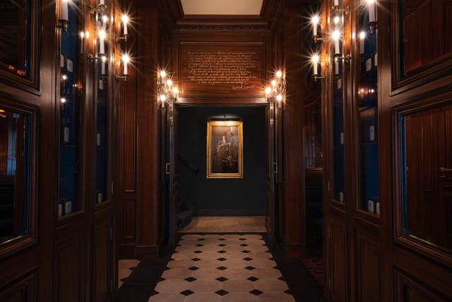 Elegant library hallway with warm wood paneling for events and receptions.