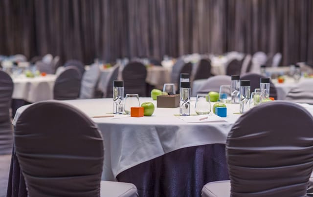 Conference Room at Hotel ICON with elegant round tables for corporate events and meetings.