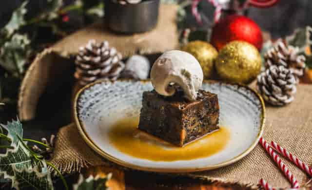 "Festive dessert at St Christopher's Inn Christmas party with cake and ice cream."