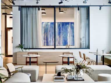 Modern meeting room with large windows, ideal for networking events and intimate meetings.
