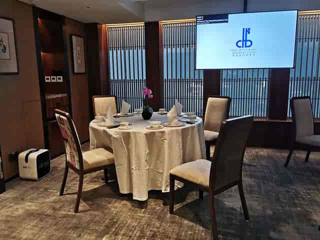 Private dining room with round table and elegant decor for meetings or events.