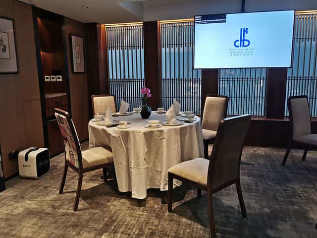 Private dining room with round table and elegant decor for meetings or events.
