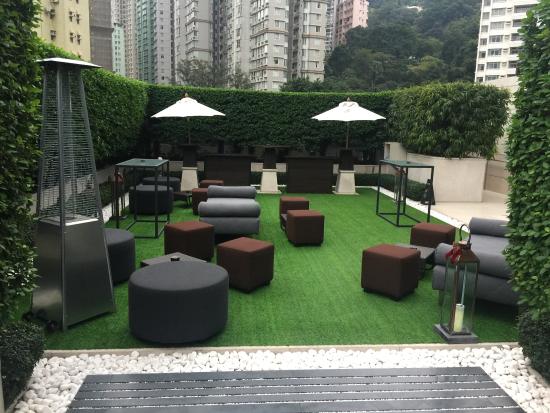 Stylish outdoor event space with modern furniture and greenery for cocktail receptions.