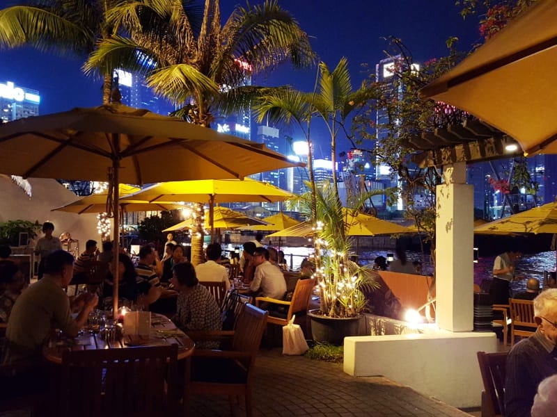 Rooftop dining at Royal Hong Kong Yacht Club with city skyline, perfect for events.