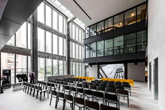Modern event space with large windows, ideal for corporate meetings and workshops.