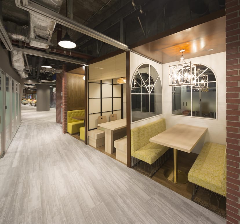 Modern coworking space with cozy booths for collaboration and networking in Shaw Creative Hub.