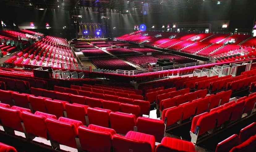 Empty arena with red seats in AsiaWorld-Expo, ideal for concerts and conferences.