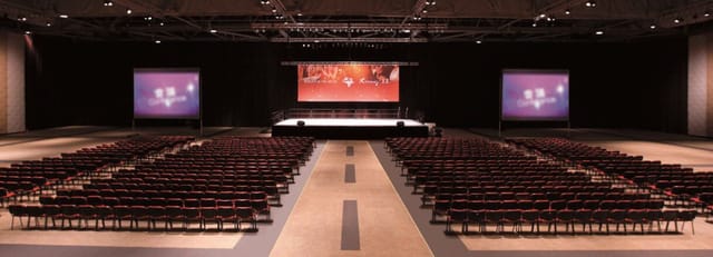Runway 11 at AsiaWorld-Expo, spacious conference venue with stage and screens.