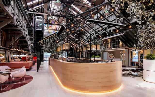 Modern venue with wooden bar, ideal for networking events and social gatherings.