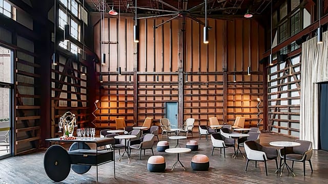 Modern event space at Ovolo Hotels with warm wood tones, ideal for corporate gatherings.