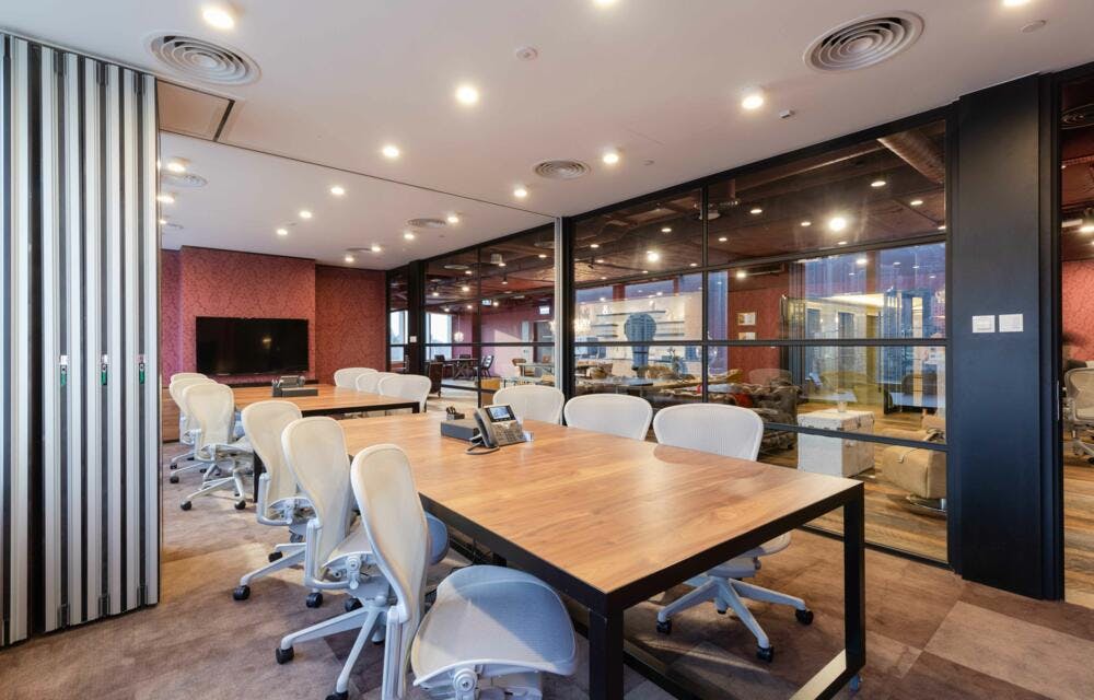 Modern meeting room with wooden table, ideal for team meetings and brainstorming sessions.