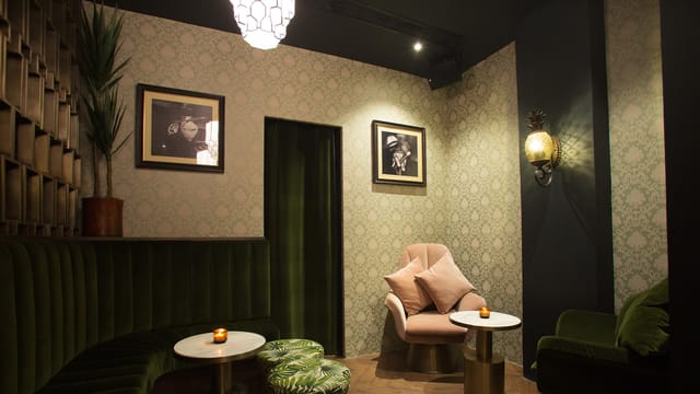 Stylish bar with plush seating, ideal for networking events and small gatherings.