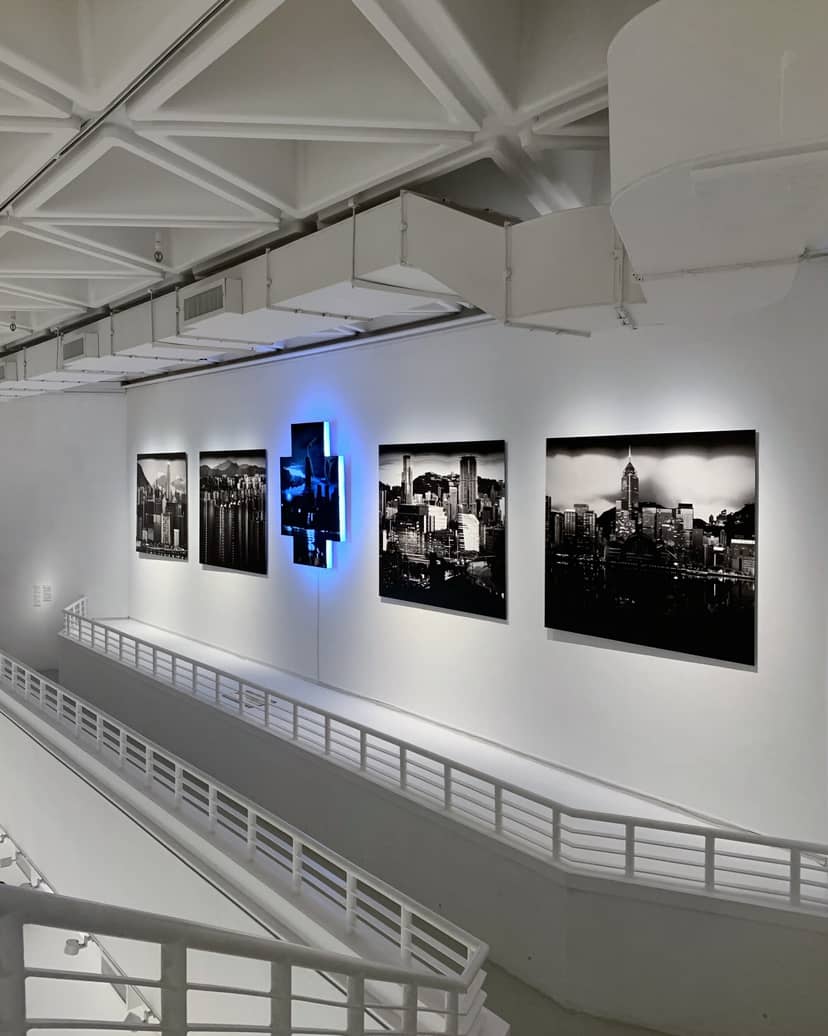 Modern gallery in Hong Kong Arts Centre with striking black-and-white cityscape photos.