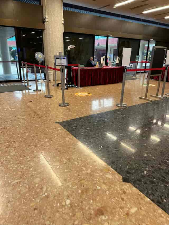 Tuen Mun Town Hall conference room registration area with check-in desk and stanchions.