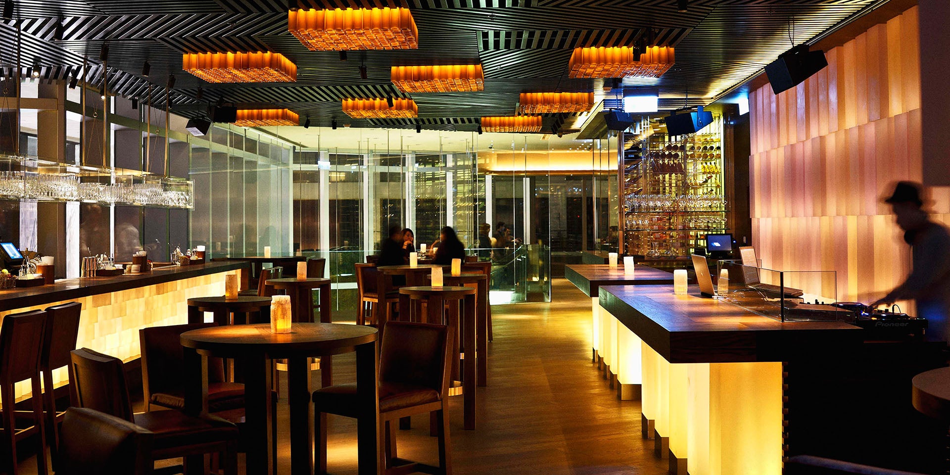 Modern Zuma bar with warm lighting, ideal for networking events and cocktail receptions.