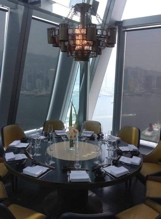 Sophisticated aqua Hong Kong dining room with elegant table setting for corporate events.