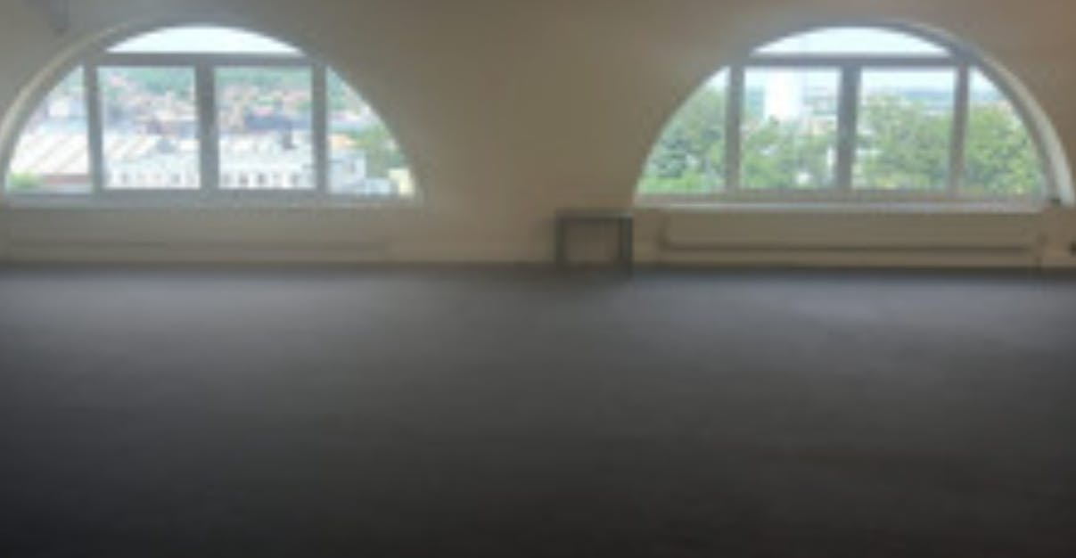 Spacious venue with arched windows for meetings and workshops at The Hope Centre.