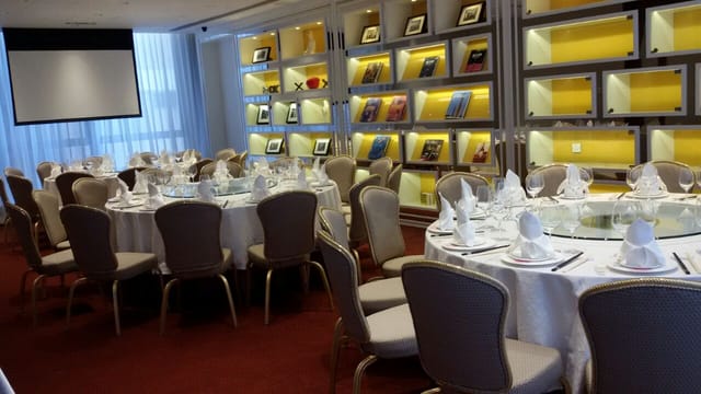 Conference Center at Hotel Indigo Hong Kong Island with elegant round tables for corporate events.