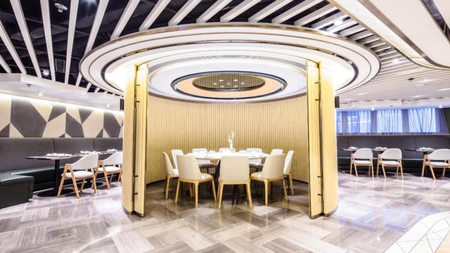 Modern meeting room with circular layout for intimate corporate events at Hotel COZi.