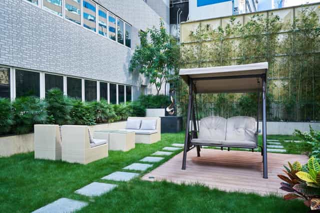 Serene outdoor meeting room with swing, ideal for networking events and casual meetings.