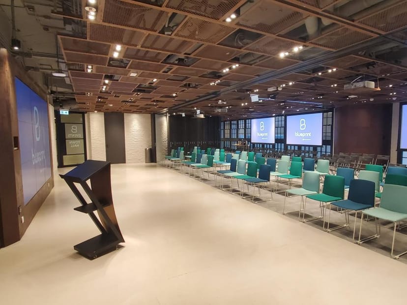 Modern conference room with colorful chairs for corporate presentations and workshops.