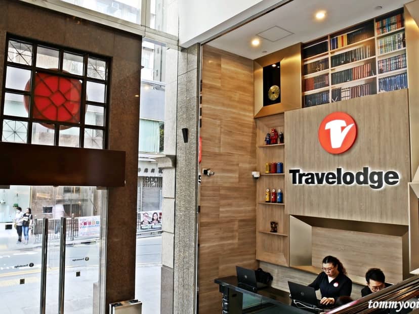 Modern Travelodge hotel reception with warm wood tones, perfect for business events.