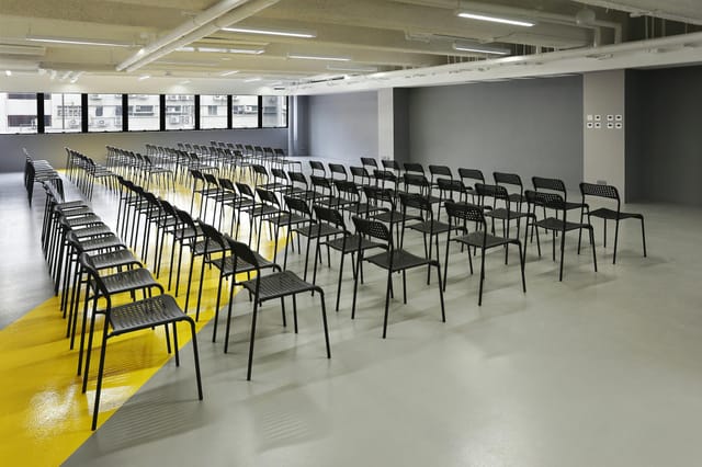 Event space with black chairs for a professional seminar in The Wave.