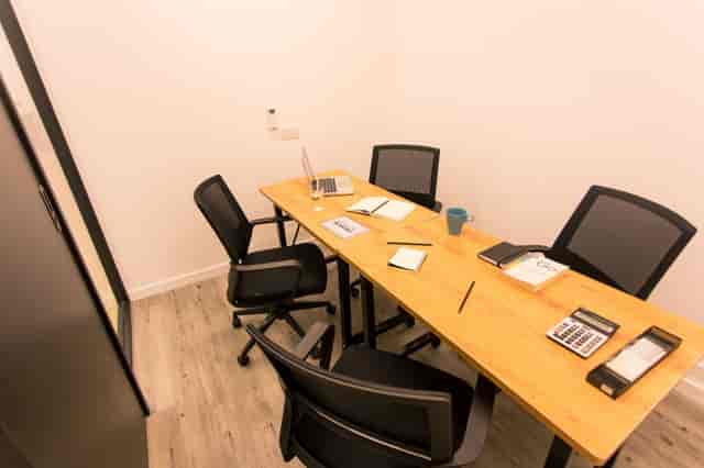 Modern meeting room with wooden table for productive coworking sessions in HK Works.