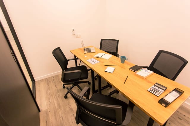Modern meeting room with wooden table for productive coworking sessions in HK Works.