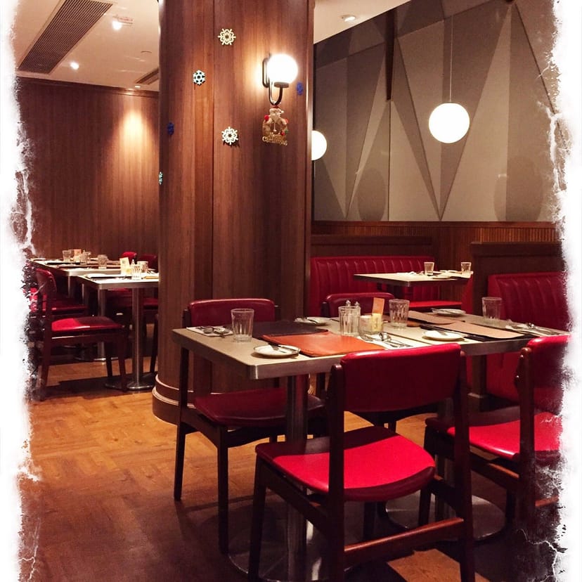 Stylish dining area with red leather seating for intimate gatherings or corporate events.
