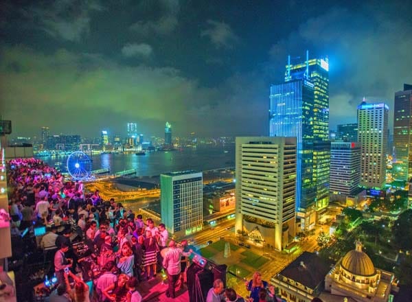 Vibrant SEVVA rooftop lounge with city skyline, perfect for networking events and celebrations.