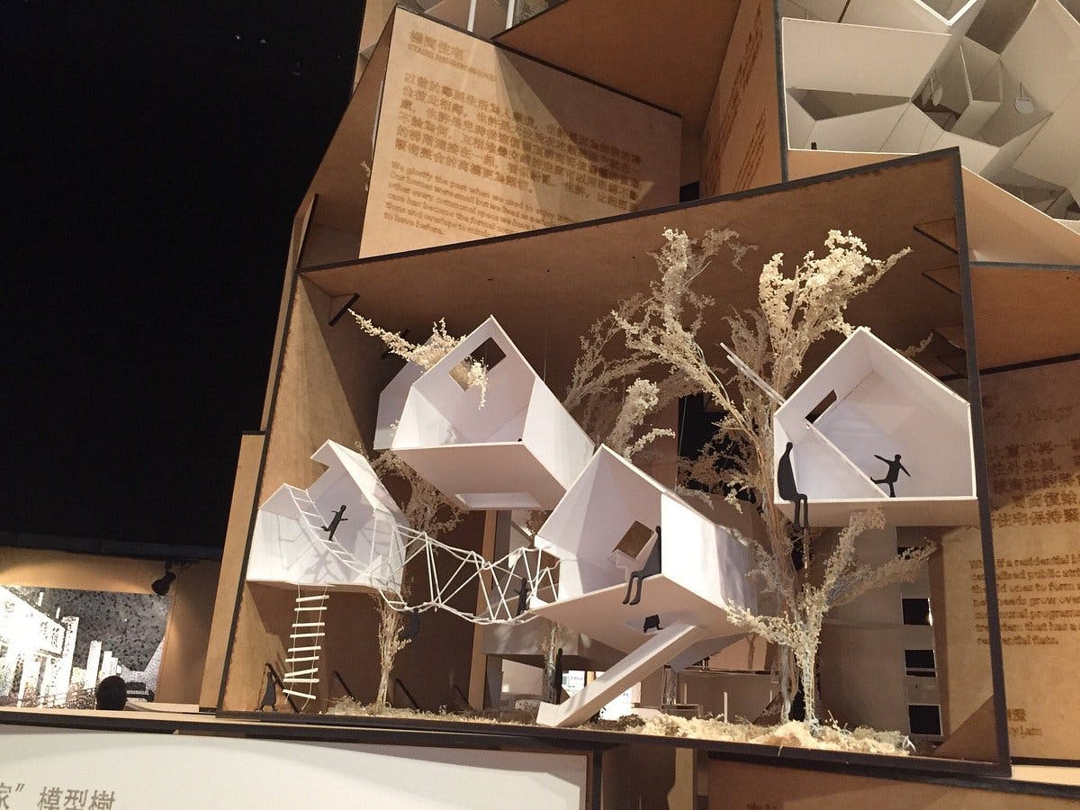 ArtisTree architectural model with minimalist structures for creative event venues.