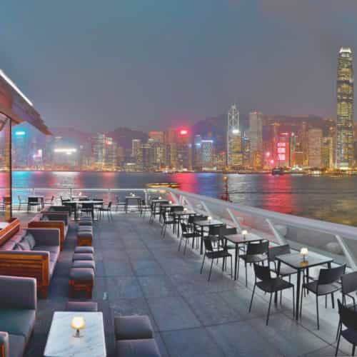 Outdoor bar terrace with Hong Kong skyline, perfect for upscale events and receptions.
