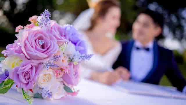 Disney Fairy Tale Weddings in Hong Kong Disneyland with pastel rose bouquet, romantic ambiance.