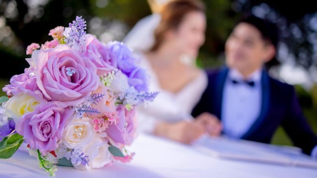 Disney Fairy Tale Weddings in Hong Kong Disneyland with pastel rose bouquet, romantic ambiance.