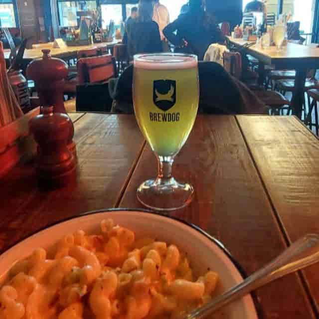 Beer garden at BrewDog Lothian Road with wooden table, ideal for networking events and casual dining.