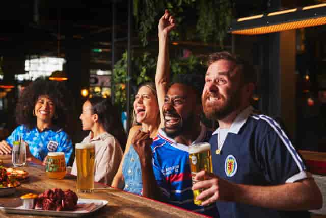 Lively group celebrating at BrewDog Lothian Road, perfect for sports events and gatherings.