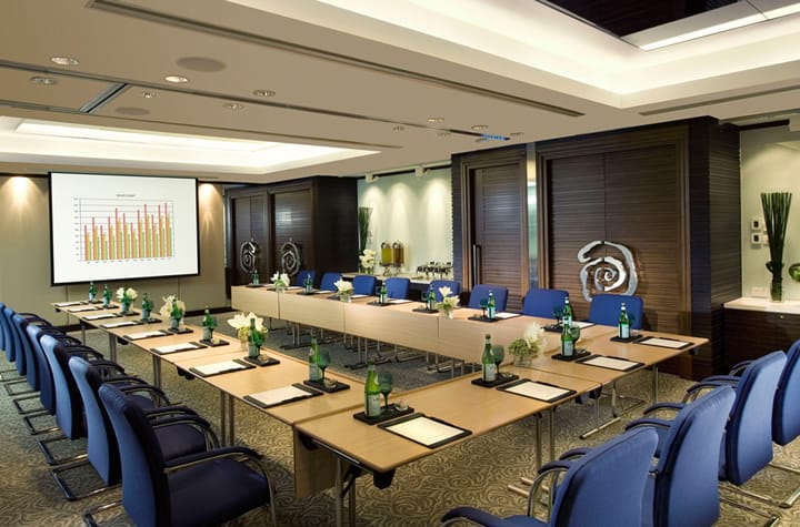 Conference Hall at Regal Hongkong Hotel with blue chairs, ideal for professional meetings.
