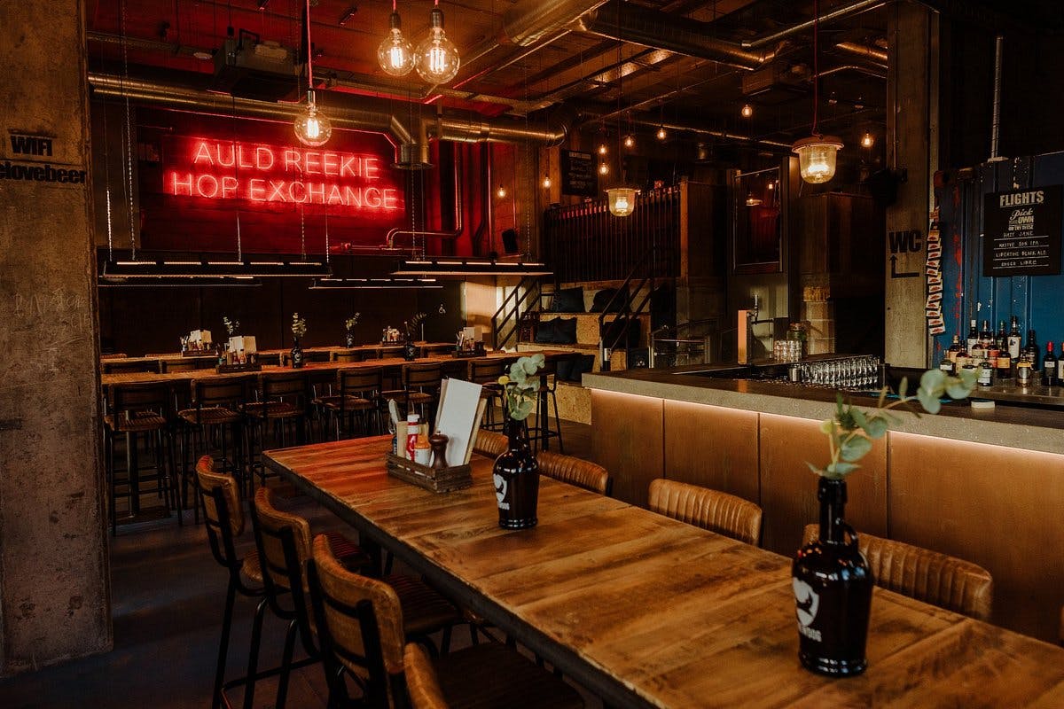 Stylish BrewDog Edinburgh bar with rustic tables, ideal for casual gatherings and events.