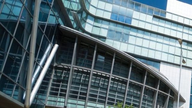 Modern glass facade of Cyberport Conference & Exhibition Centre for corporate events.