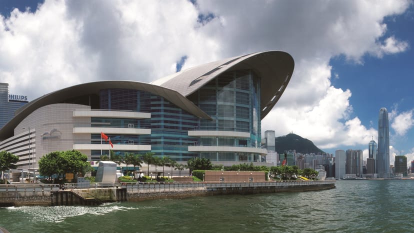 Modern waterfront conference center with sweeping roofline, ideal for events and exhibitions.