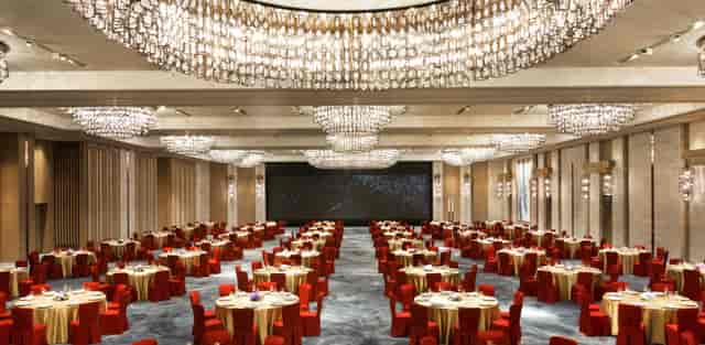 Hung Hom Ballroom, Kerry Hotel: elegant event space with gold tables and red chairs.
