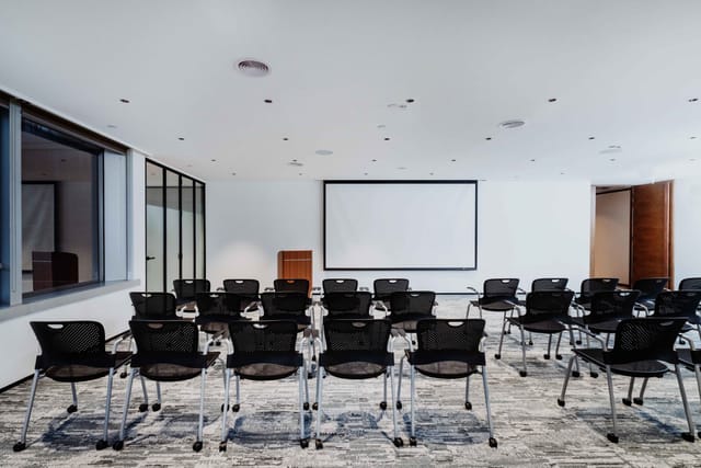 Versatile meeting room with movable chairs for workshops and presentations at Eaton Club.
