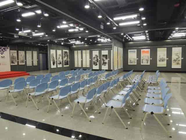 Exhibition Space in Sheung Wan Civic Centre with blue chairs for a seminar event.